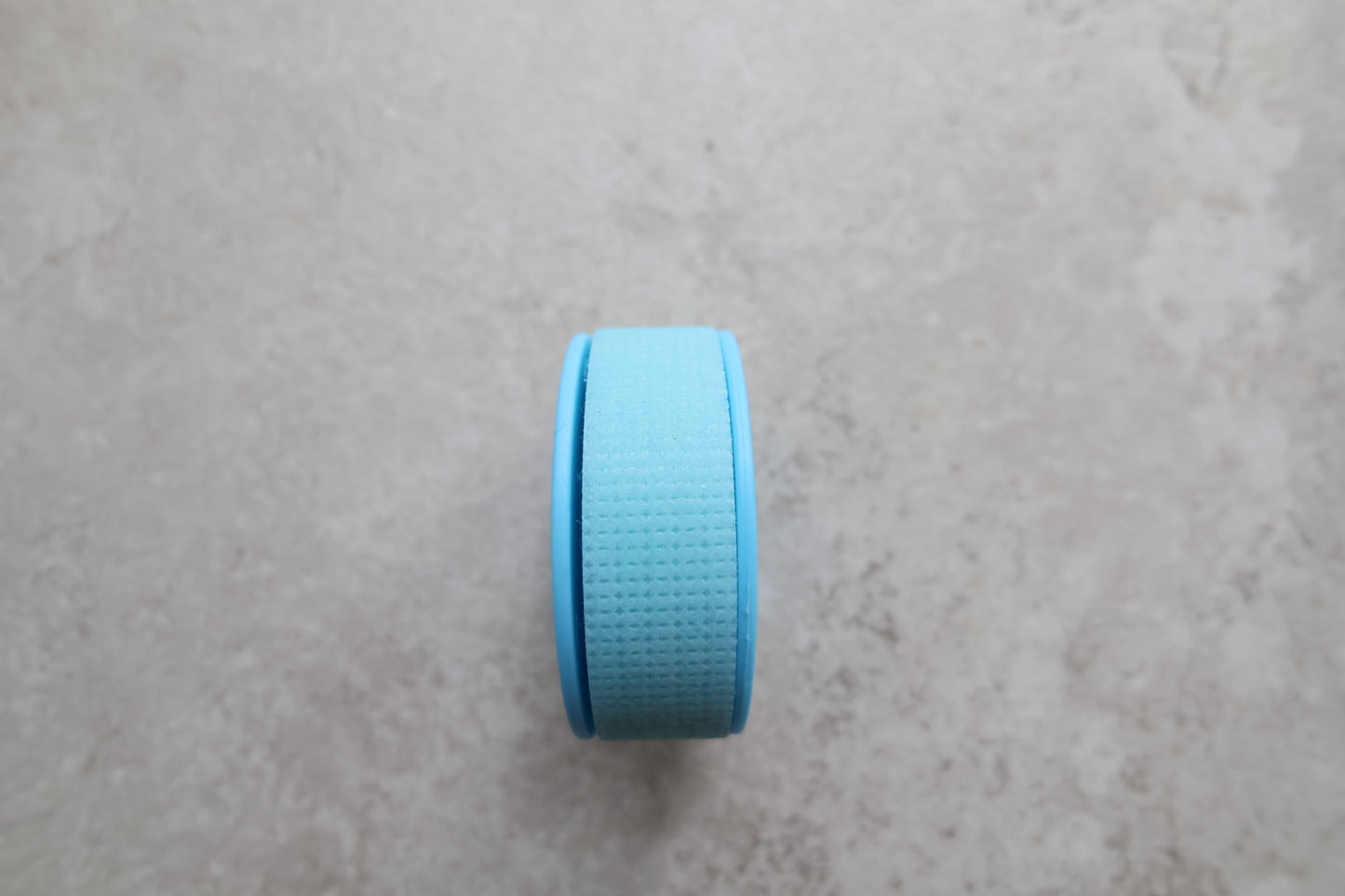 Blue cap on a textured gray surface